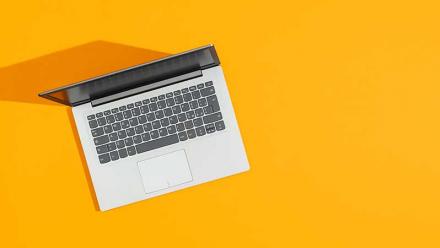 laptop on a bright yellow background