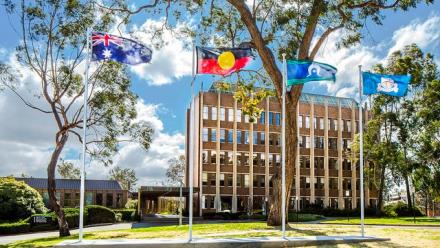 Flag poles at front of the Chancellery Building, The Australian National University Canberra ACT.