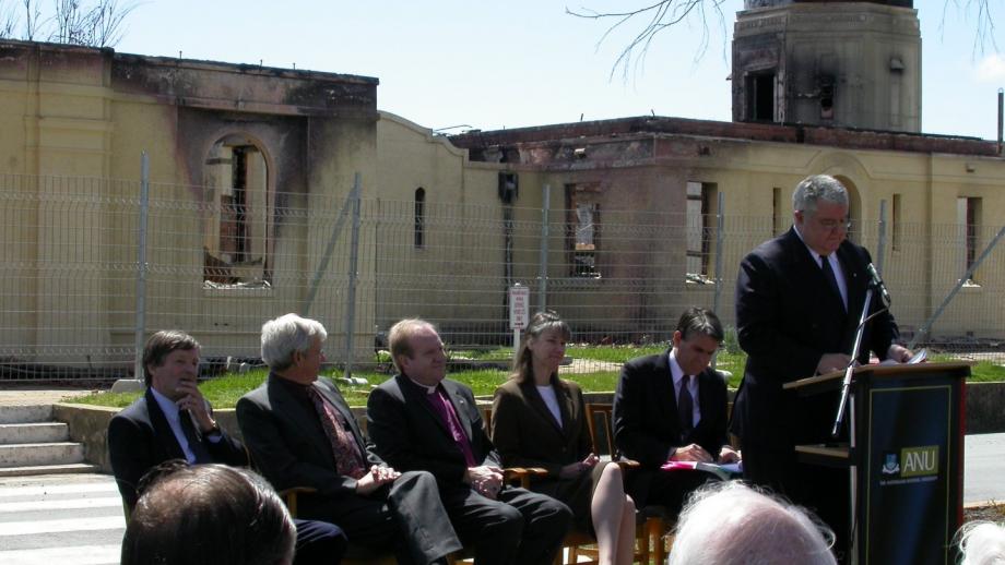 VC Ian Chubb addresses Stromlo staff with destroyed CSO building at rear (Mt Stromlo Archives)