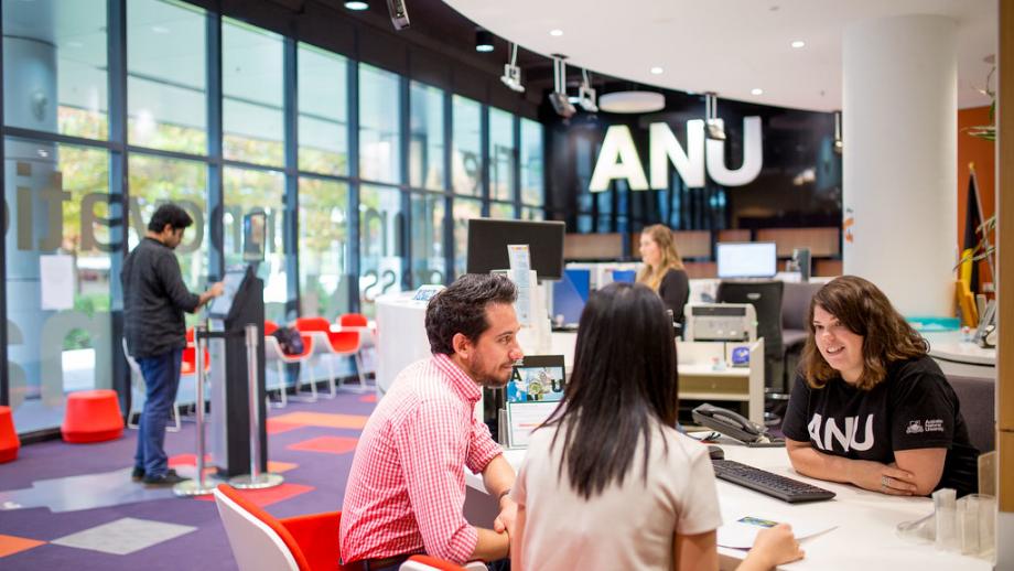 ANU staff member speaking with students